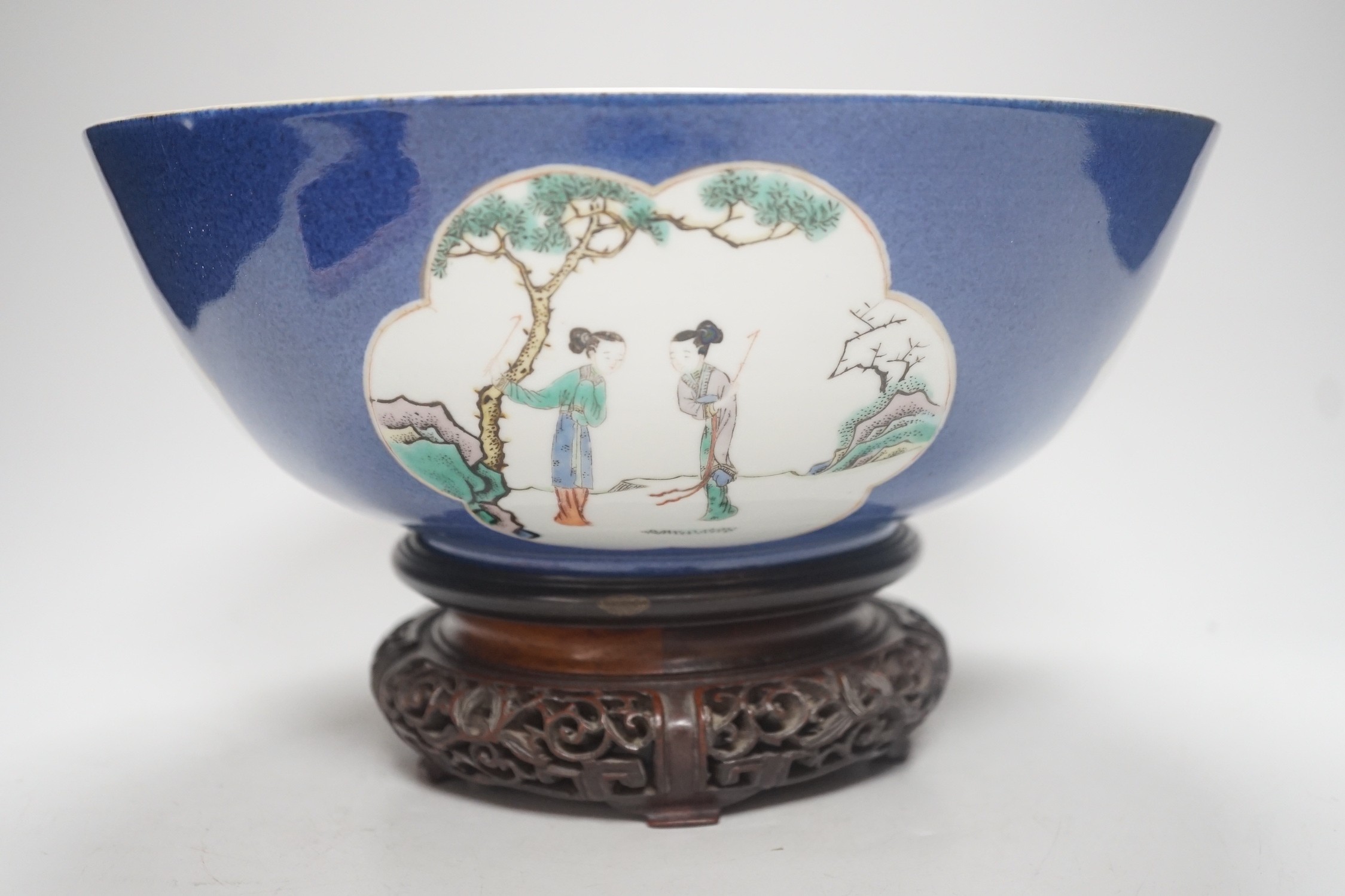 A 19th century Chinese famille verte powder blue bowl, 26cm diameter, wood stand